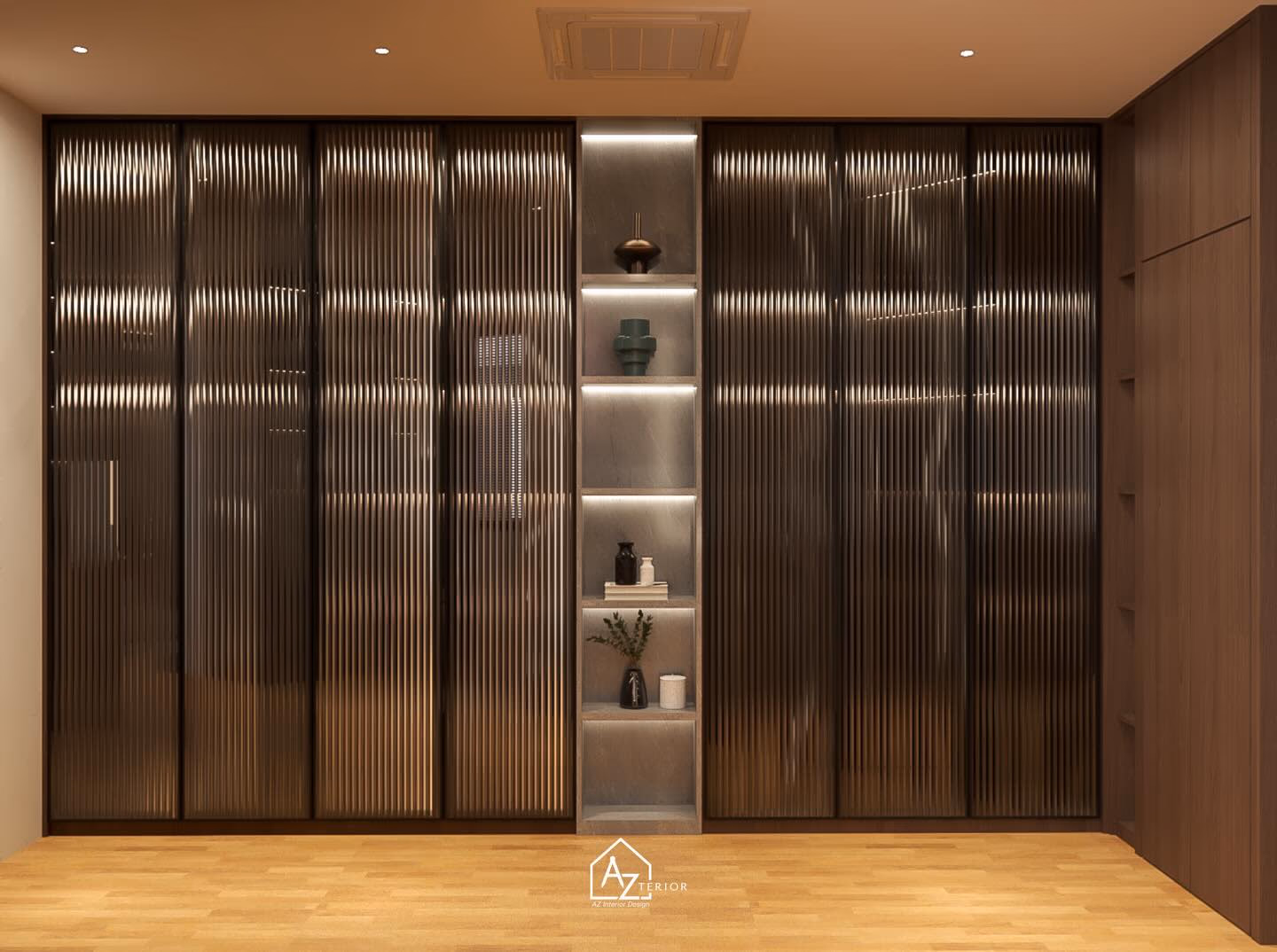 A full wall of reeded bronze-tinted glass wardrobe doors, split by a lit stone display column