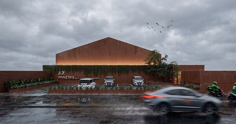The street elevation in the rain — a gabled terracotta volume behind a planted screen wall, lit signage above the forecourt