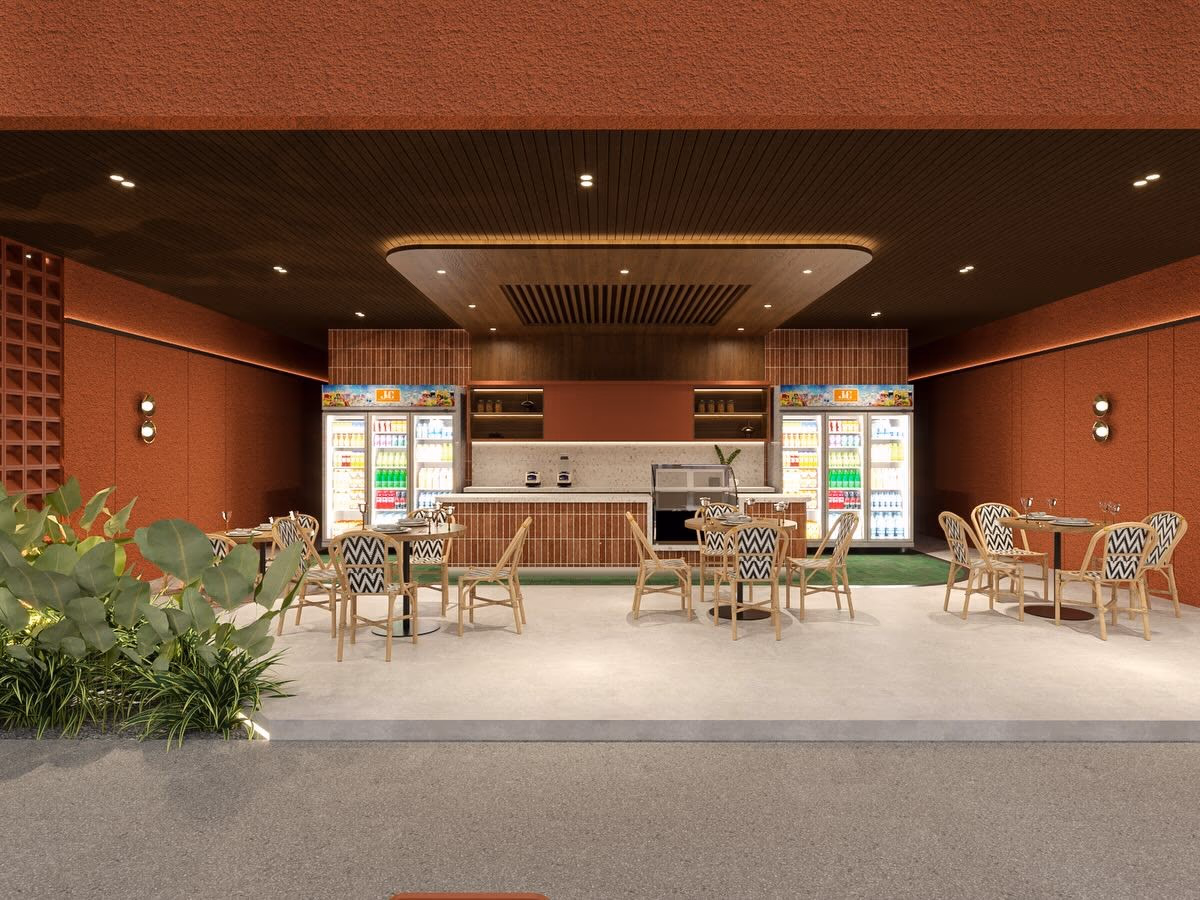 The café counter in terracotta brick beneath a slatted timber ceiling, with bistro seating and open coolers