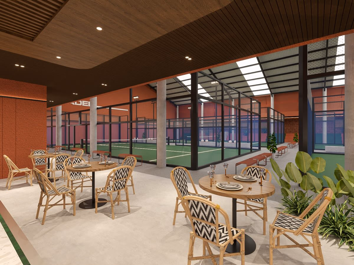 The full run of courts seen from the café, skylights washing the steel structure above them