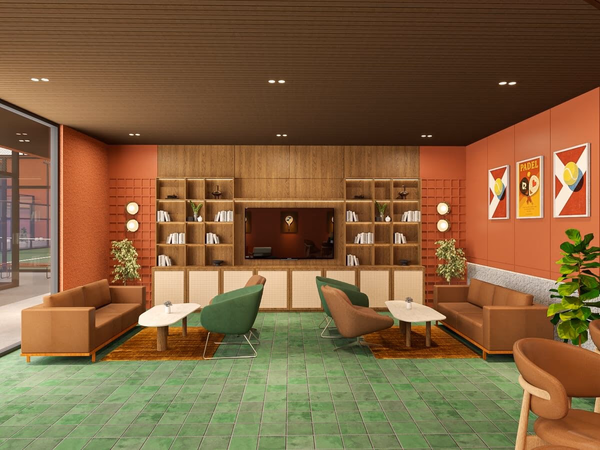 A clubhouse lounge with tan leather sofas on a green tiled floor, courts visible through the glazing