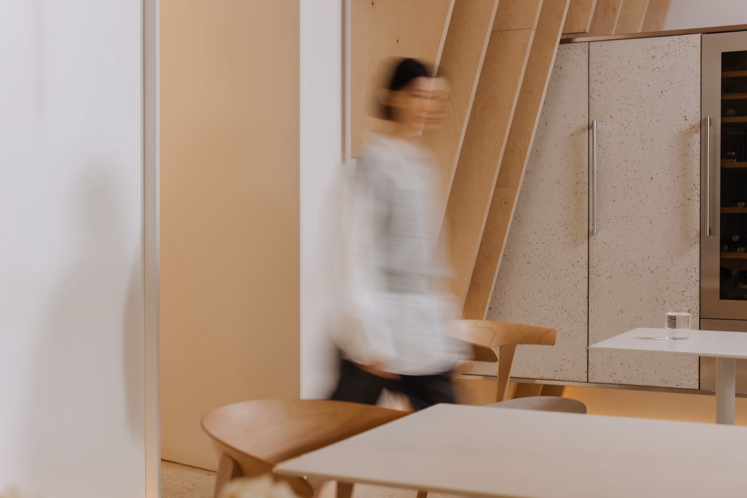 The Azterior Project atelier in Jakarta, a member of the studio crossing the workspace under north light
